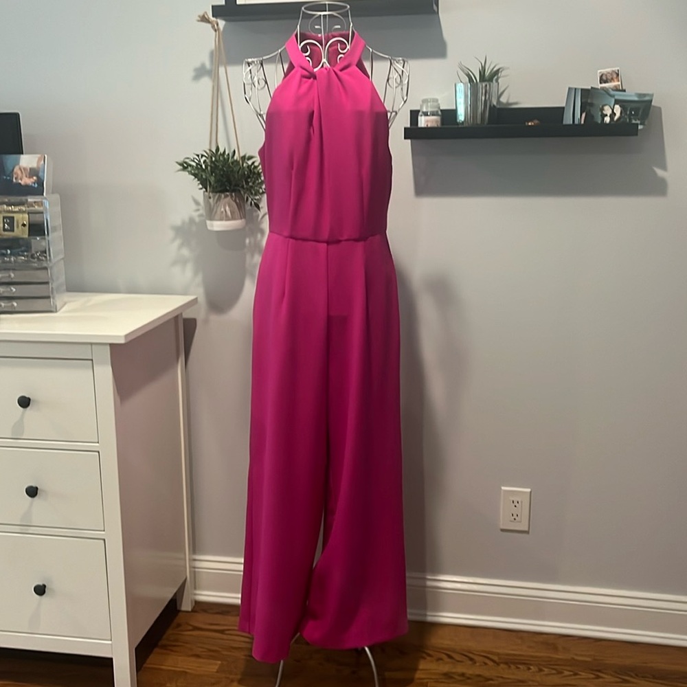 Bright pink full length flared jumpsuit with halter neck. Size 8